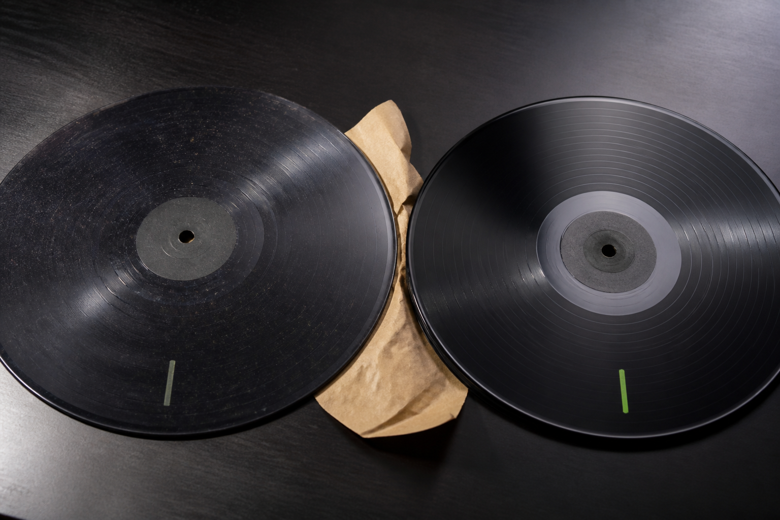 Two lacquer discs showing noisy versus clean groove surfaces